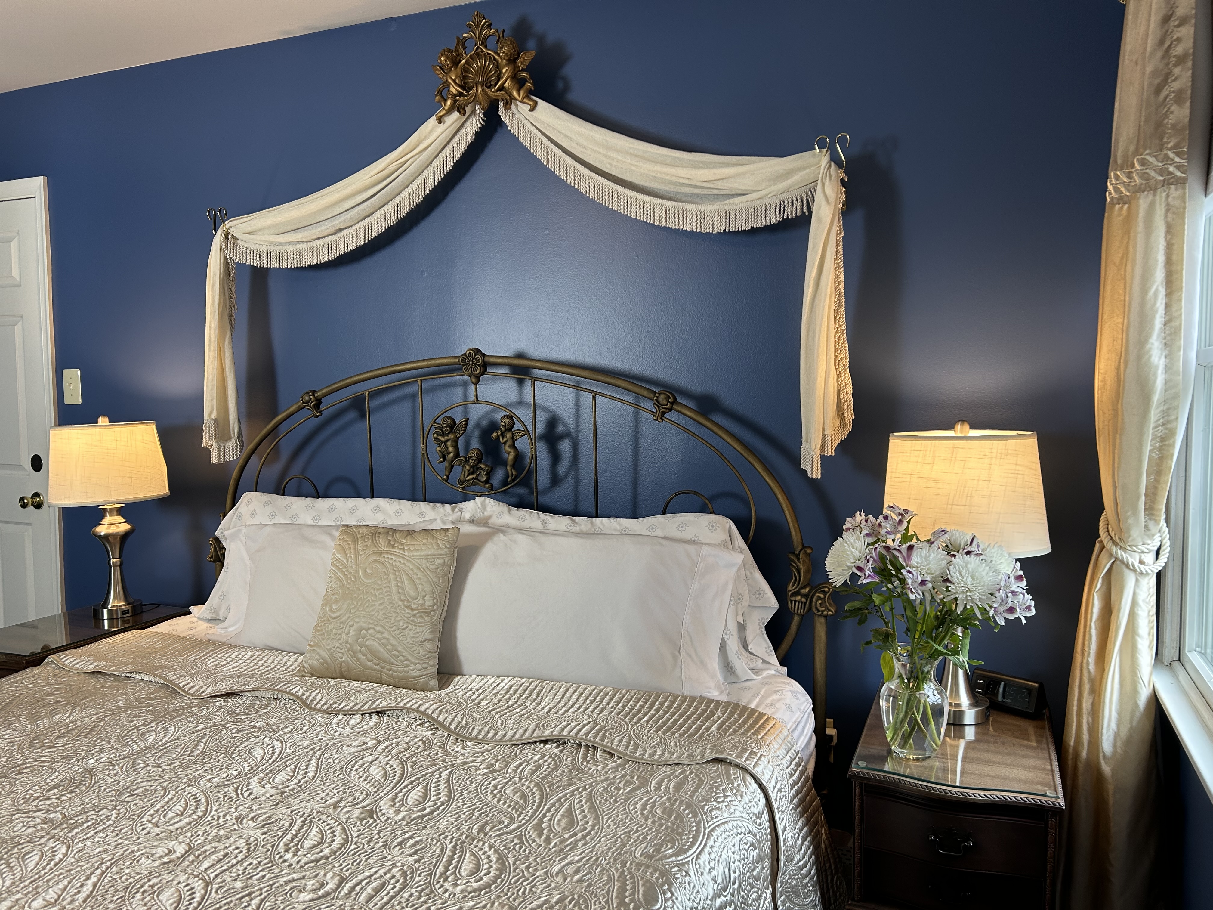 View of king size bed with side tables and lamps
