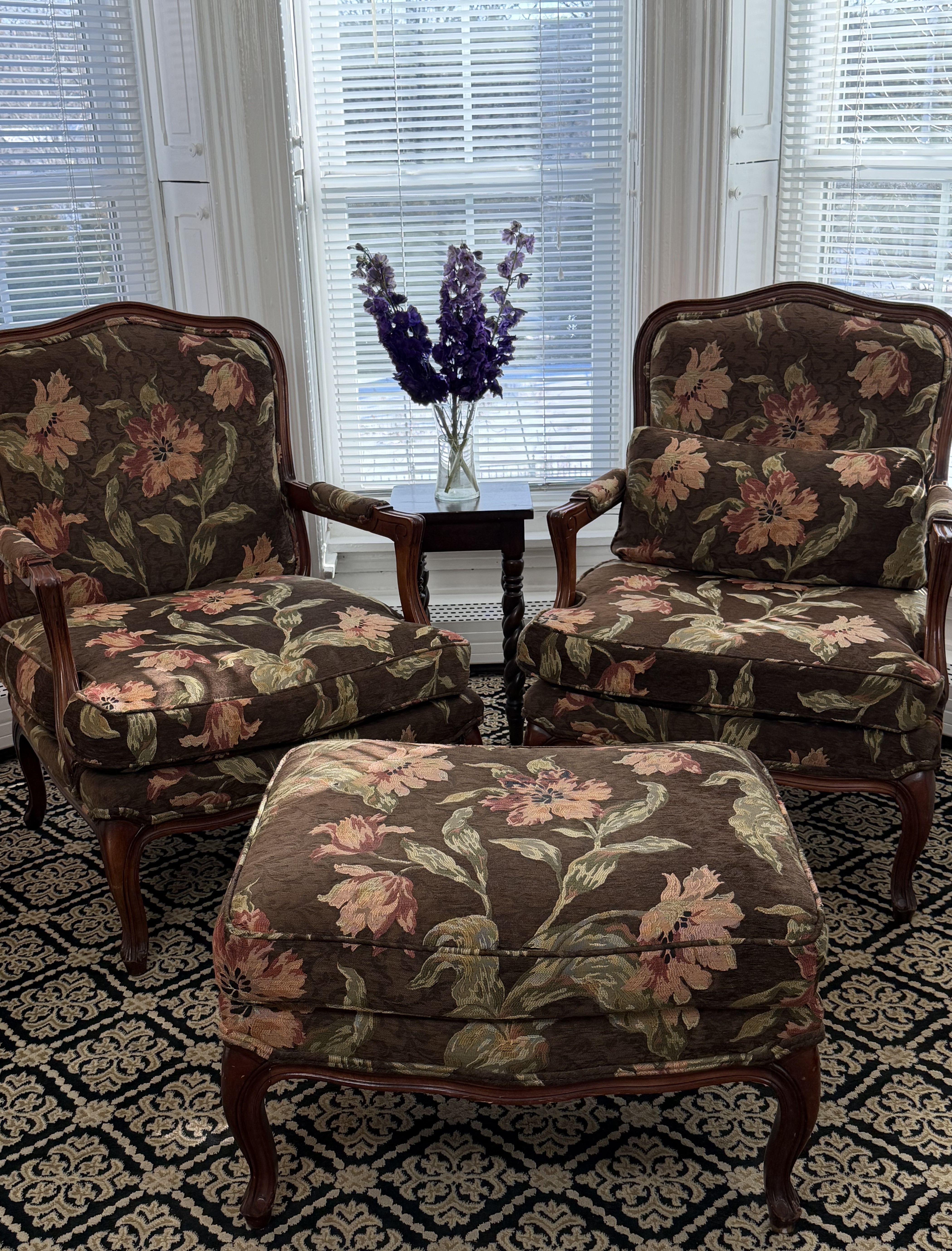 View of bay windows & sitting area with flowers