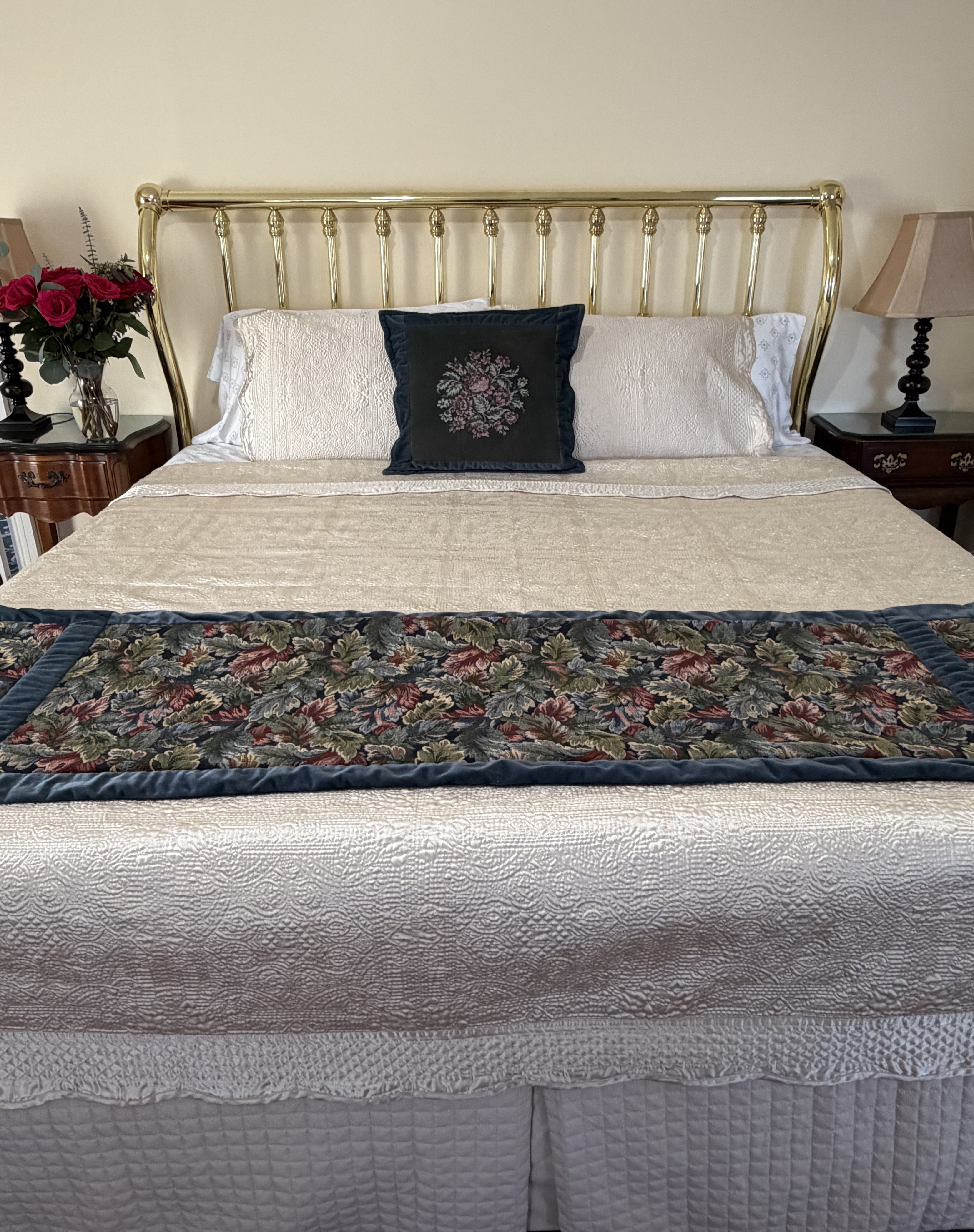 Front view of king bed with brass headboard