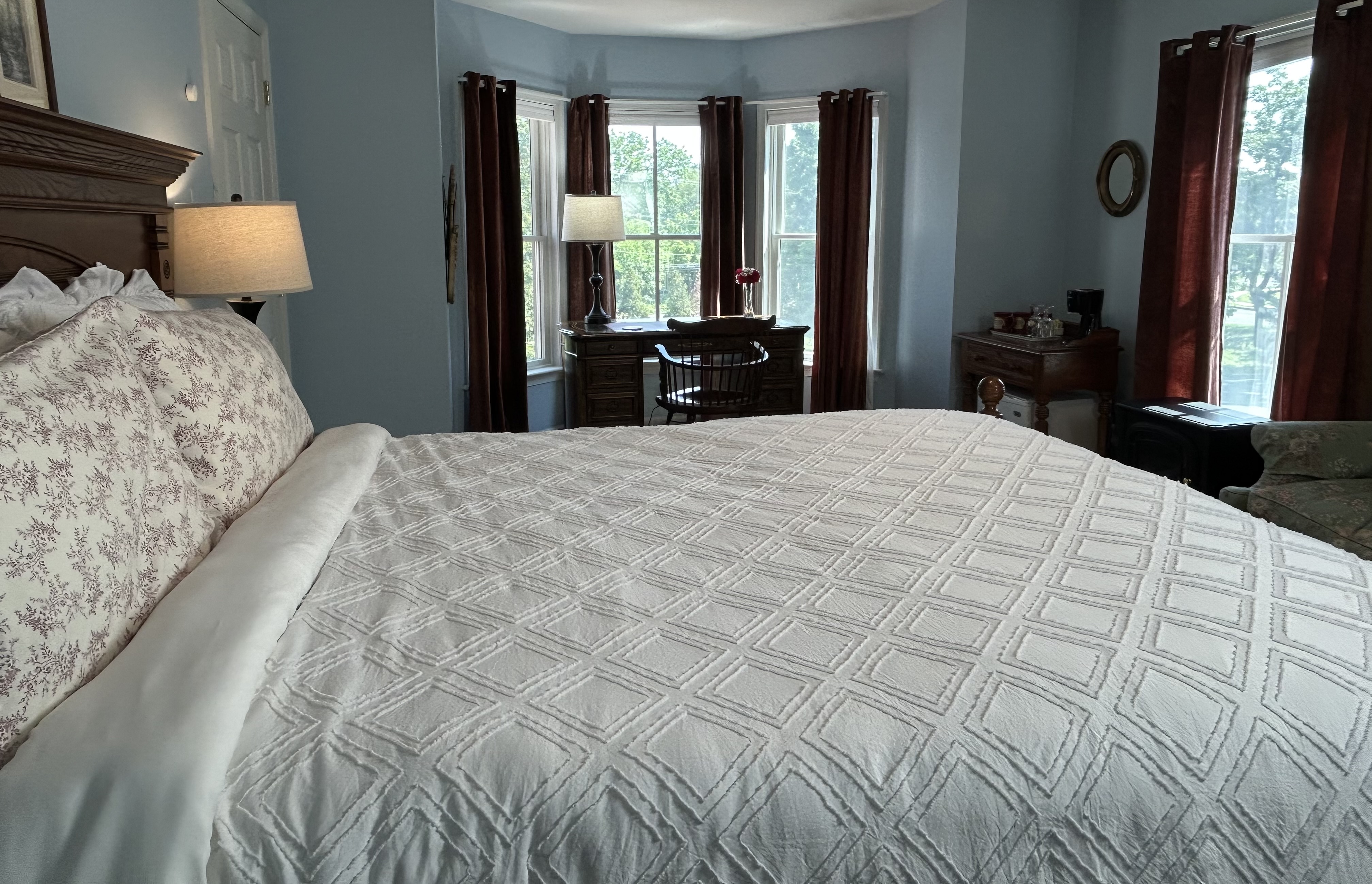 View of room toward bay windows with desk