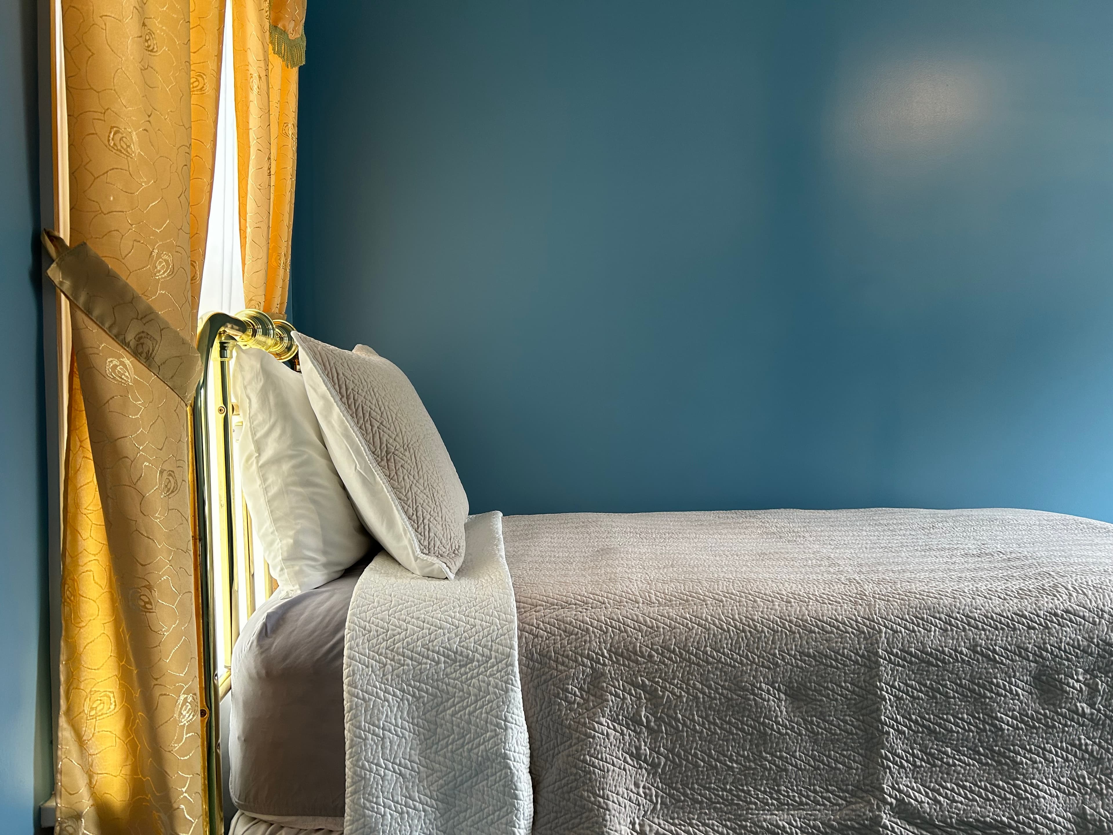 View of twin bed with window in adjunct room