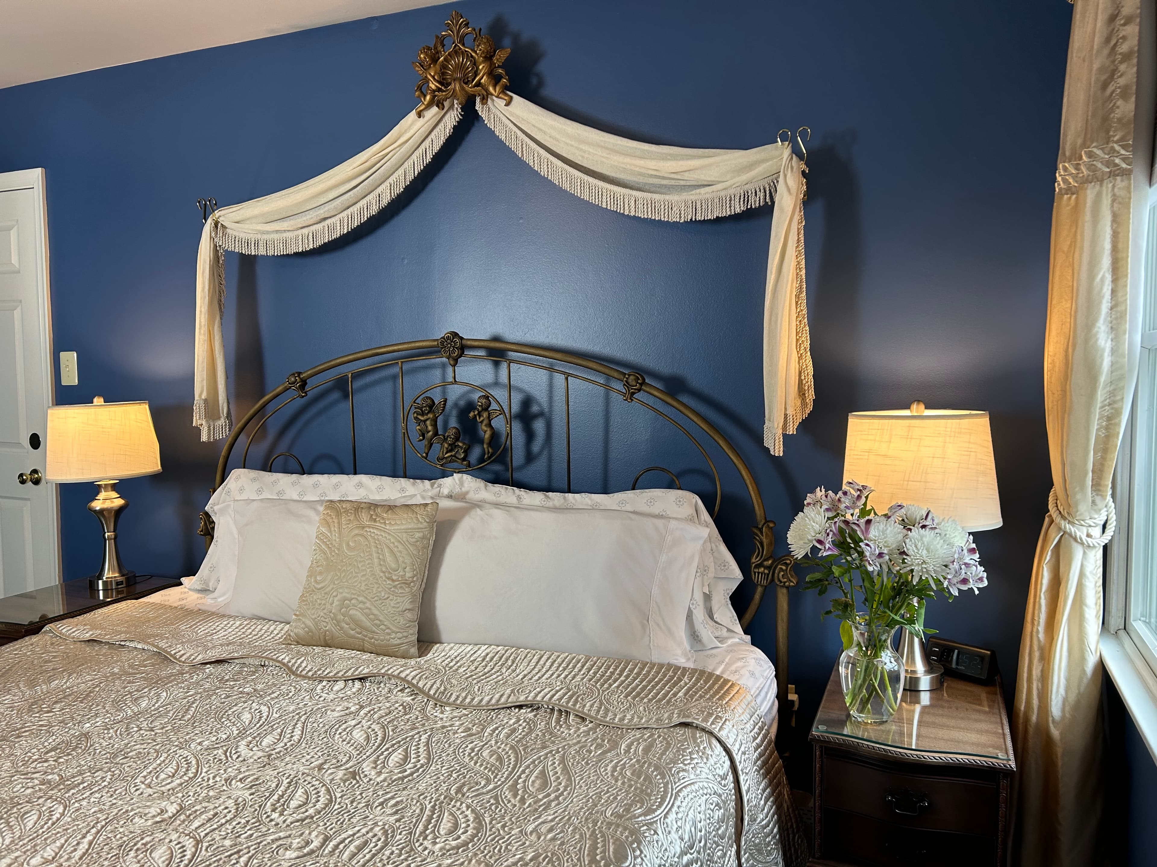 View of king size bed with side tables and lamps