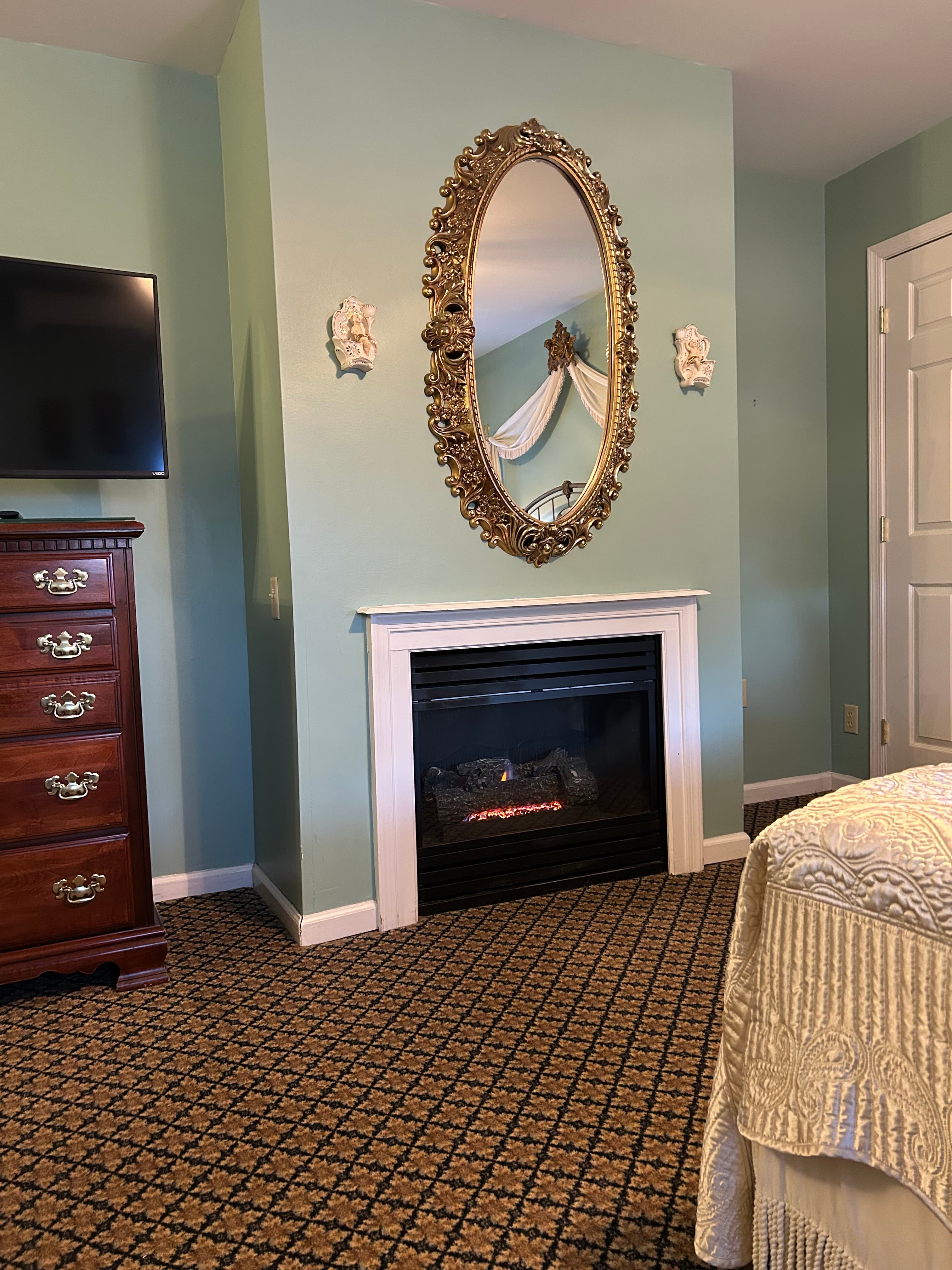 View of gas fireplace, dresser and TV