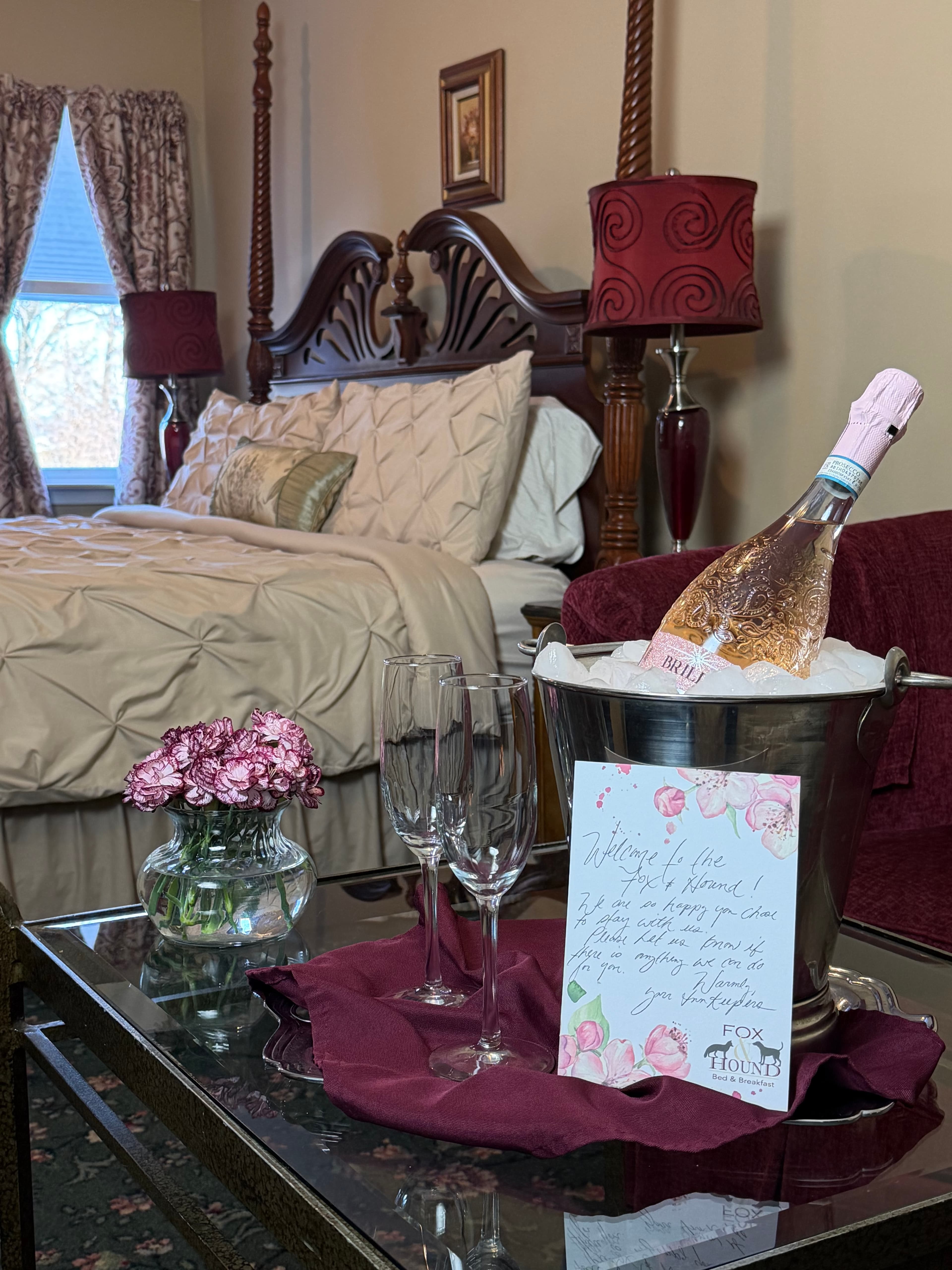 View of sitting area to the bed with champagne & a welcome note