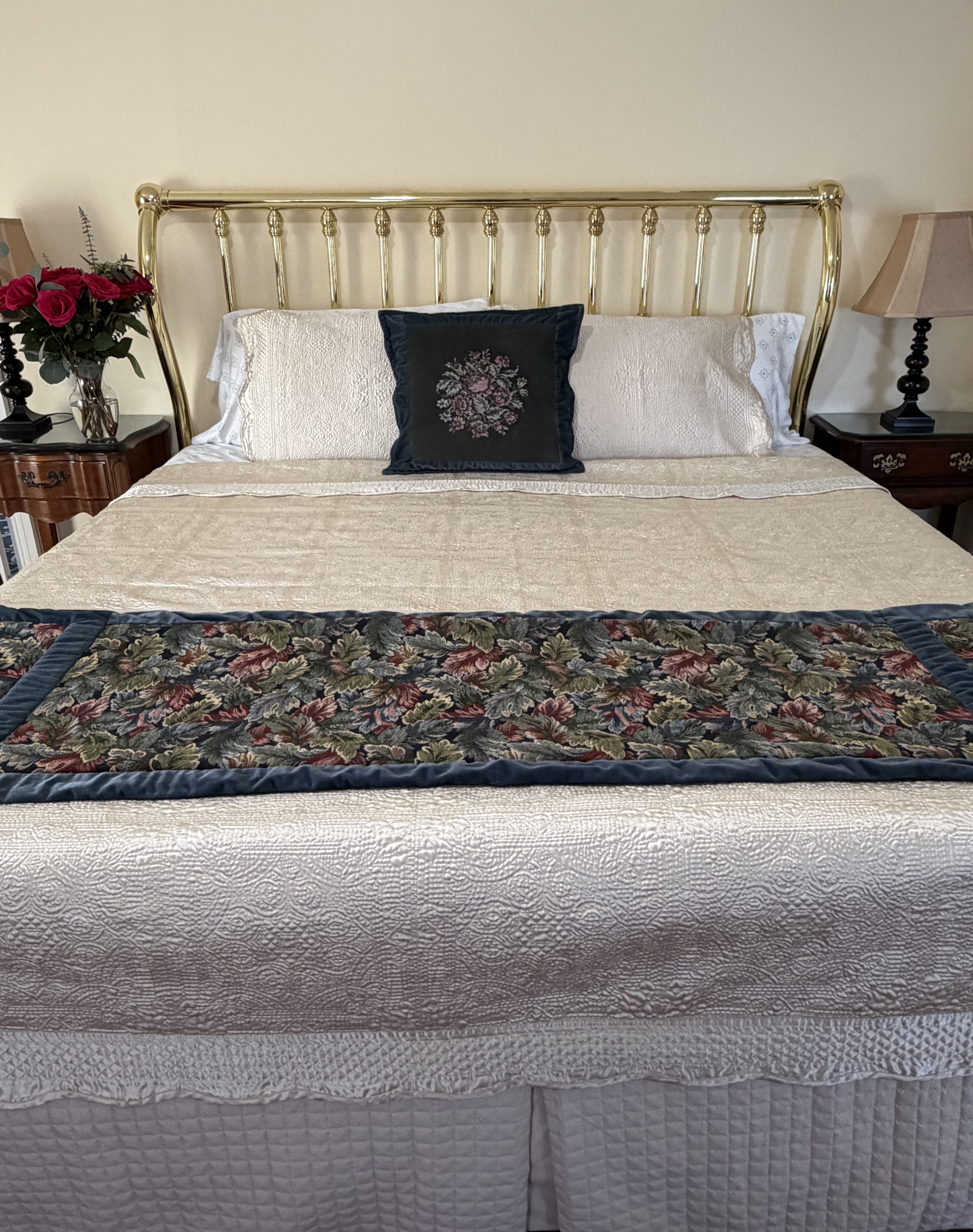 Front view of king bed with brass headboard