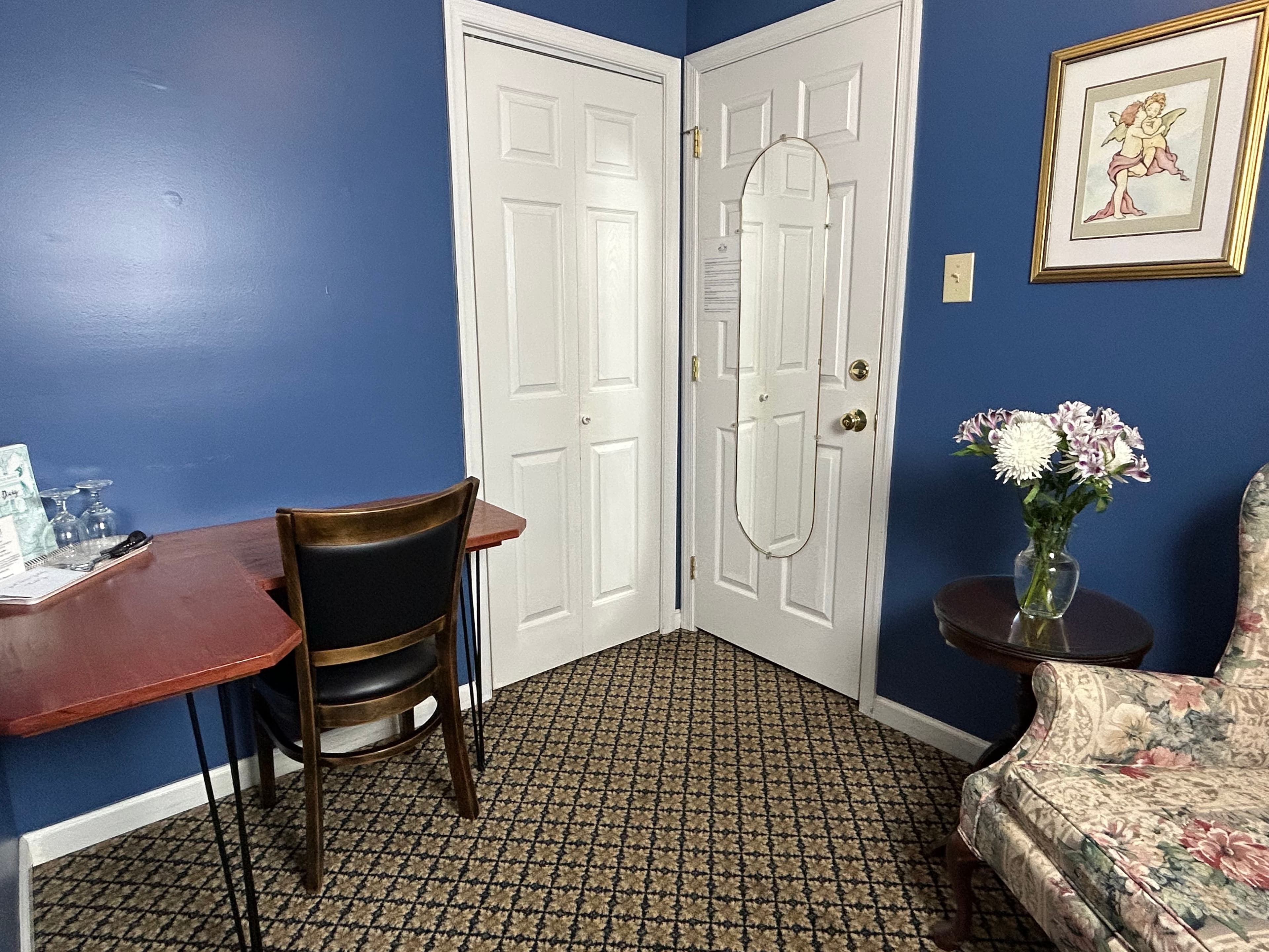 View of desk, closet and front door